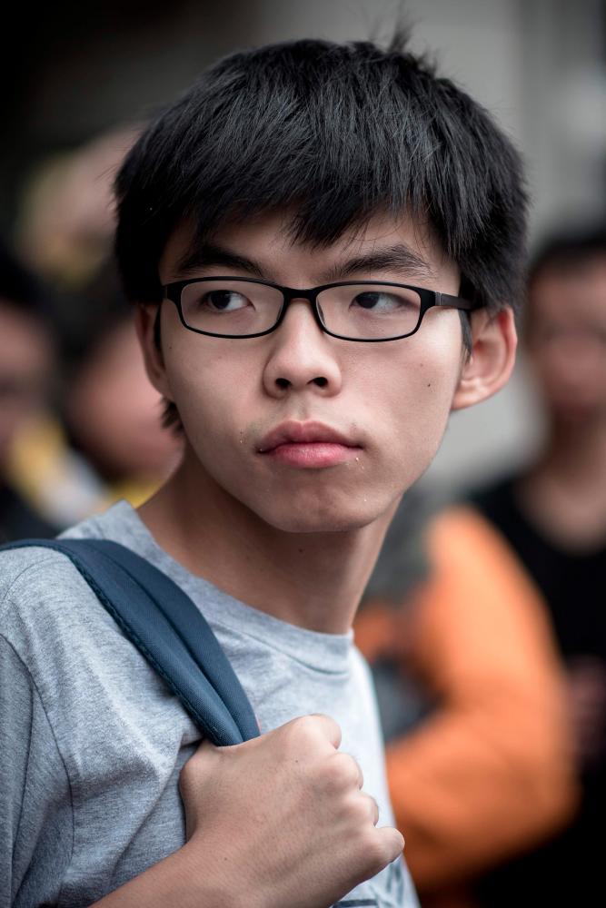 This file picture taken on Oct 26, 2015 shows student protester Joshua Wong outside a court of justice in Hong Kong. — AFP