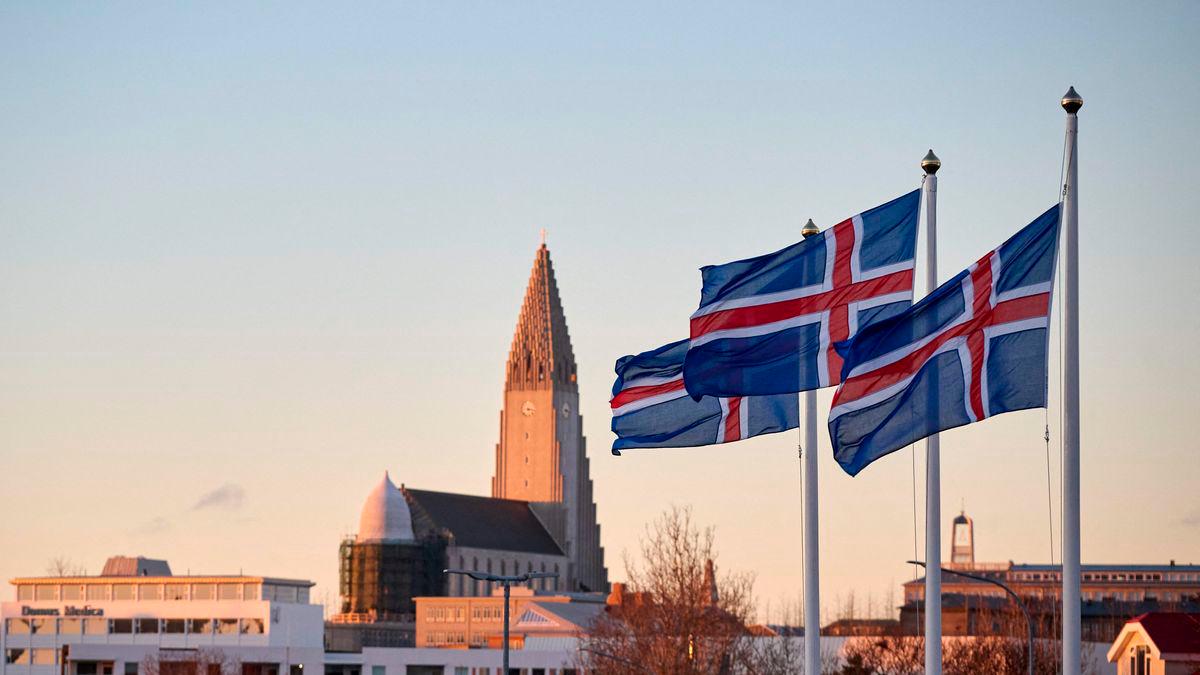 Icelandic national flags are seen flying outside a polling station, as the Hallgrimskirkja church is seen in the background, in Reykjavik, Iceland, on Nov 30,