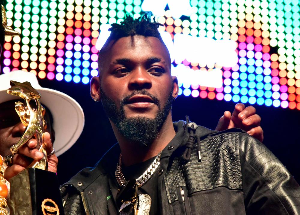 Ivory Coast’s musician DJ Arafat holds the award for best artist of the year during the Coupe-Decale Awards in Abidjan. — AFP