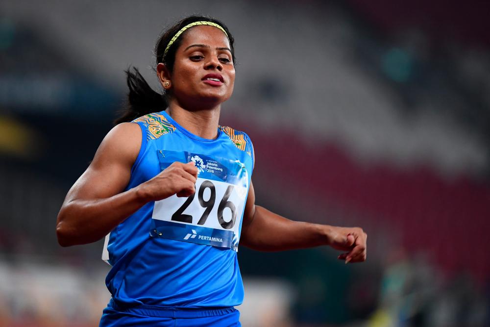 In this file photo taken on Aug 26, 2018 India's Dutee Chand competes in a semi-final heat of the women's 100m athletics event during the 2018 Asian Games in Jakarta. — AFP