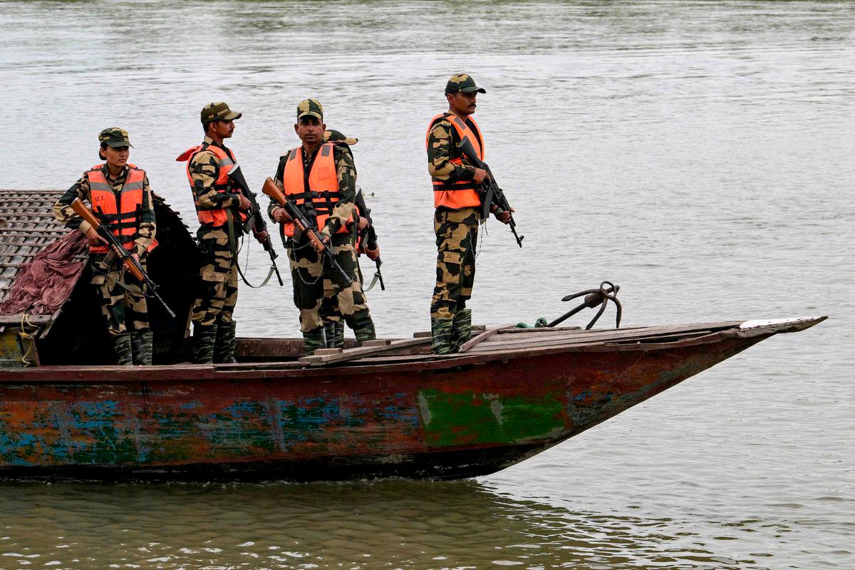 Border Security Force (BSF) personnel riding a boat patrol along the Gangadhar river near the India-Bangladesh border in Golakganj, Dhubri district in India’s Assam State on May 26, 2025. - AFPPIX