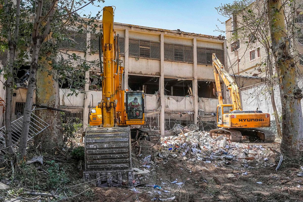 (FILES) Excavators are used to clear the rubble outside the Evin prison complex in Tehran that was hit days ago by an Israeli strike. - Mostafa Roudaki / MIZANONLINE / AFP