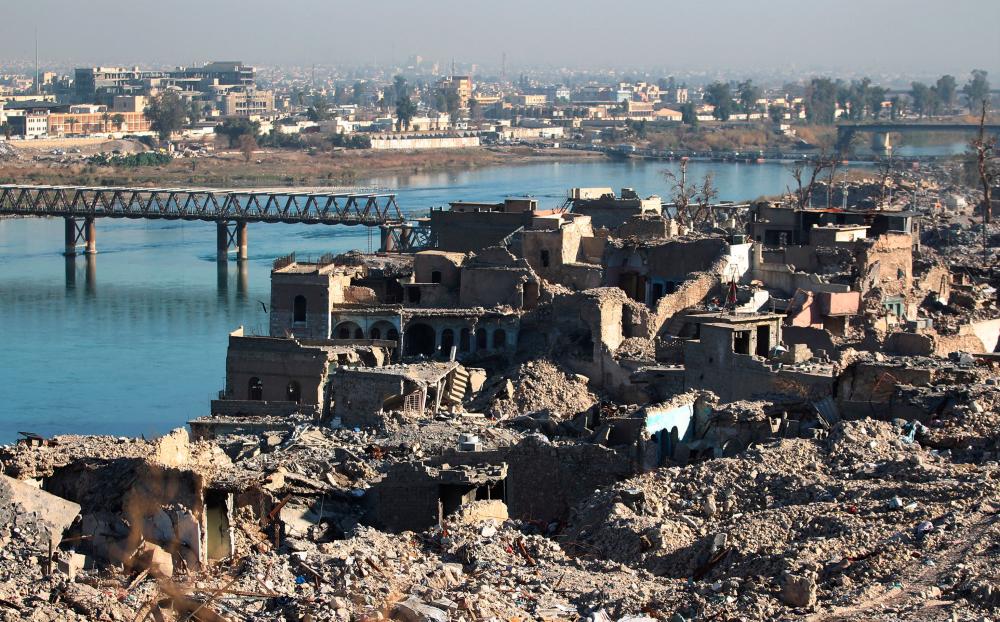 In this file photo taken on Jan 09, 2018 A picture shows the destruction of the old city of Mosul with the city's old bridge over the Tigris river in the background. — AFP