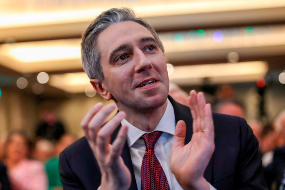 Simon Harris applauds during the Fine Gael convention at the Sheraton Hotel in Athlone, central Ireland on March 24, 2024, before being declared leader and de facto prime minister-in-waiting/AFPPix