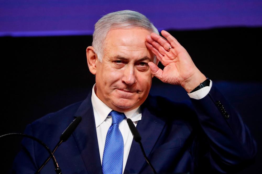 In this file photo taken on April 10, Israeli Prime Minister Benjamin Netanyahu gestures as he addresses supporters at his Likud Party headquarters in the Israeli coastal city of Tel Aviv. — AFP