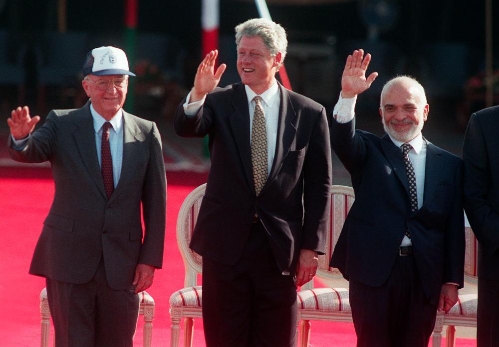 In this file photo taken on Oct 26, 1994, US President Bill Clinton (C), Jordan's King Hussein (R) and Israeli Prime Minister Yitzhak Rabin, wave to the crowd during the signing ceremony of the Israeli-Jordanian peace accord held at the Wadi Araba border crossing. — AFP