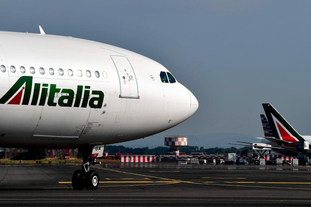 An Alitalia airplane is seen rolling on the tarmac at the Fiumicino Airport, in Rome. Italy’s Atlantia group, owned by the Benetton family, is ready to take a stake in ailing flagship carrier Alitalia, as are three other new investors, Italian media reported on July 14, 2019. — AFP