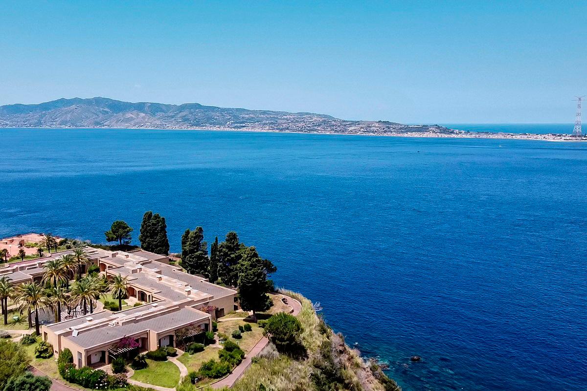 (FILES) A general aerial view shows the Sicilian coast towards Cape Torre Faro, over the Strait of Messina, taken from the outskirts of the town of Scilla, in Calabria region in southern Italy, on July 7, 2020. - Andreas SOLARO / AFP