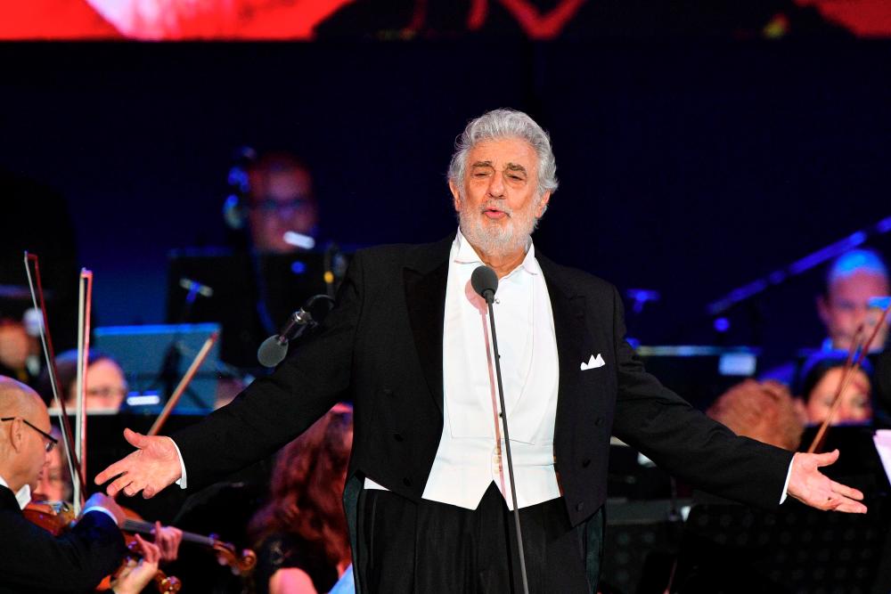 In this file photo taken on August 28, 2019 Spanish tenor Placido Domingo performs during his concert in the newly inaugurated sports and culture centre ‘St Gellert Forum’ in Szeged, southern Hungary. / AFP / Attila KISBENEDEK