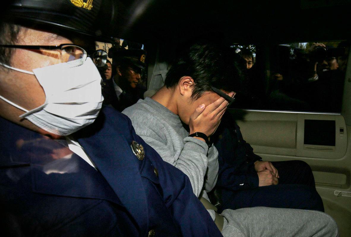This file photo taken on November 1, 2017 shows suspect Takahiro Shiraishi (C) covering his face with his hands - AFPPix