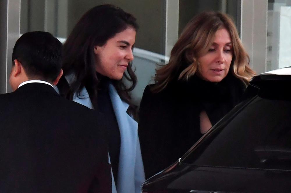 This file photo taken on Mar 6, 2019 shows Carole Ghosn (R), wife of former Nissan chairman Carlos Ghosn, and his daughter Caroline (C) leaving after Ghosn left the Tokyo Detention House following his release on bail in Tokyo. — AFP