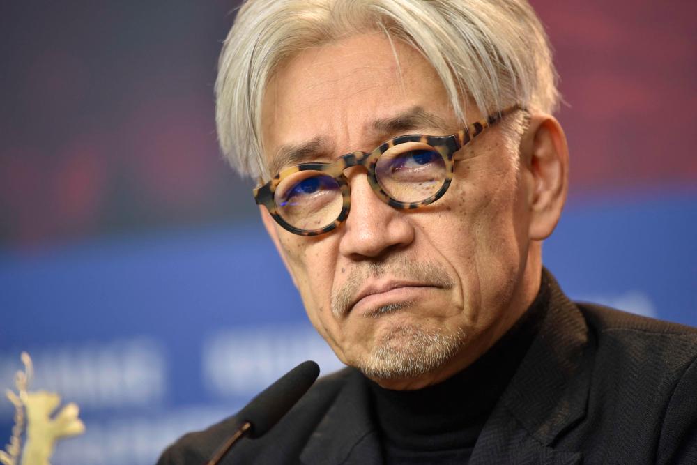 This file photo taken on February 15, 2018 shows Japanese musician and composer Ryuichi Sakamoto, jury member of the 68th edition of the Berlinale international film festival, reacting during a press conference in Berlin. AFPPIX