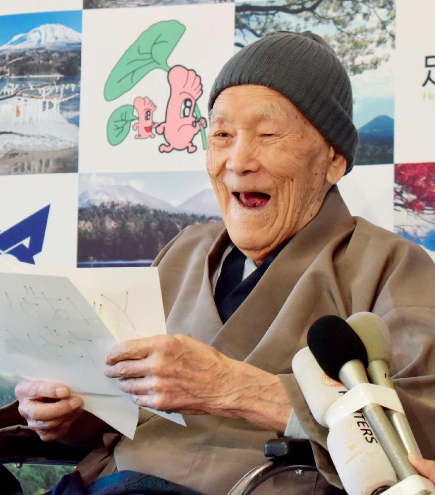 This file photo taken on April 10, 2018 shows Masazo Nonaka of Japan, then aged 112, smiling after being awarded the Guinness World Records' oldest male person living title in Ashoro, Hokkaido prefecture. — AFP / Jiji Press