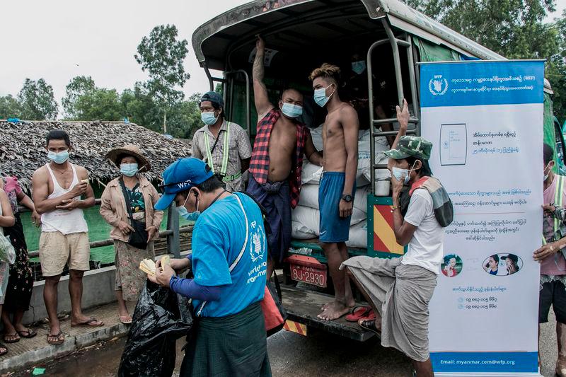 FILEpix: Photo taken on May 21, 2021. People wait to receive bags of rice distributed by the World Food Programme (WFP) as part of food aid efforts to support residents living in poor communities on the outskirts of Yangon. AFPpix