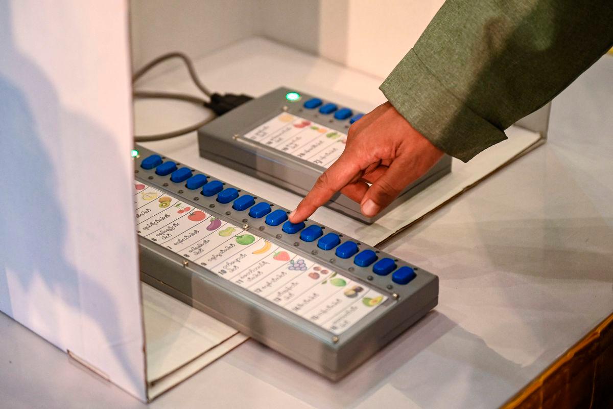 (FILES) An official shows how to use a voting machine for future elections in Yangon on September 5, 2023. Myanmar’s ruling military junta said on August 18, 2025 that the country’s election will start on December 28, beginning a phased poll being boycotted by opposition groups and criticised by international monitors. (Photo by AFP)