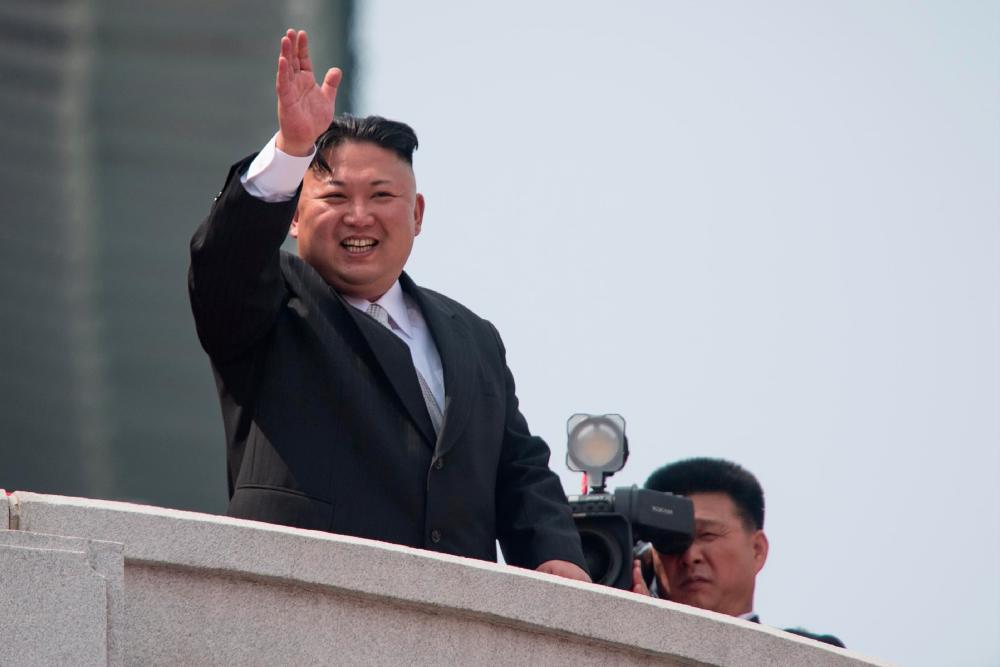 (FILES) This file photo taken on April 15, 2017 shows North Korean leader Kim Jong Un waving from a balcony of the Grand People's Study House following a military parade marking the 105th anniversary of the birth of late North Korean leader Kim Il-Sung in Pyongyang. - AFPPIX