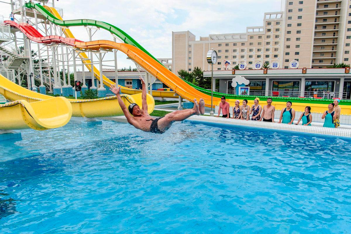 Domestic tourists watch as a man uses a slide into a swimming pool at the Myongsasimni Water Park in the Wonsan Kalma Coastal Tourist Area in Wonsan, North Korea’s Kangwon Province - AFPPix