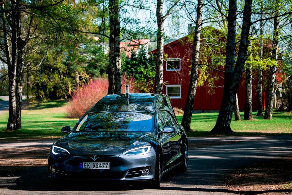 In this file photo taken on April 29, 2019 a custom made Tesla Motors car operated by a funeral services company in Norway is pictured in Oslo. While the novel coronavirus pandemic is ravaging the world, some of Norway's funerals homes ironically have found themselves without work and have turned to the state for aid. Due to declining mortality and cancelled funeral ceremonies, half a dozen Norwegian undertakers, according to a public registry, have turned to the state for aid after the initial success of Norway's handling of the COVID-19 has left them struggling to make ends meet. — AFP