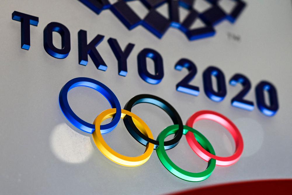 (FILES) In this file photo taken on January 28, 2021, the Tokyo 2020 Olympics Games logo is seen in Tokyo on January 28, 2021. The Brazilian delegation that will participate in the Tokyo Olympics will take a course against racism, in an attempt to bury this structural scourge in the Latin American giant. –AFP