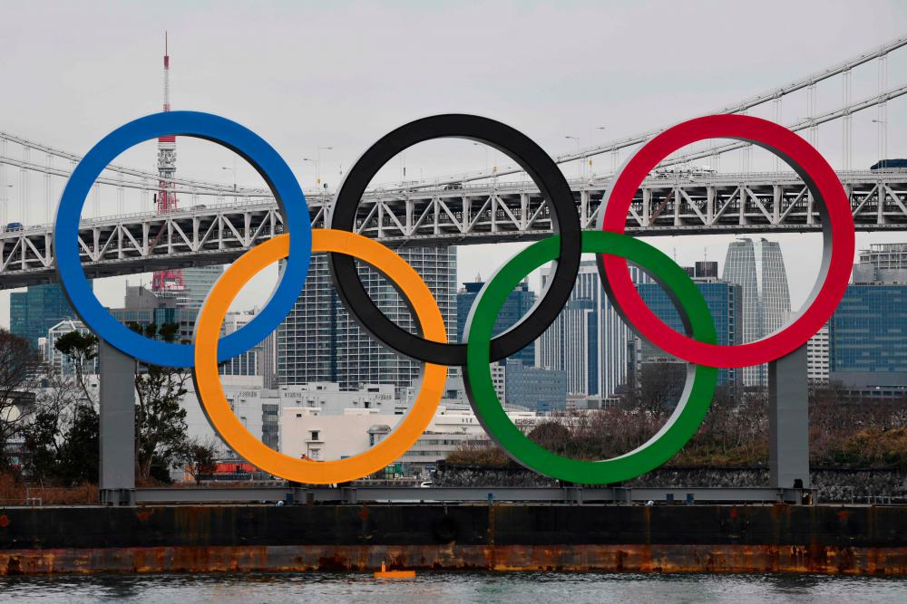 In this file photo taken on Jan 17, a large size Olympic Symbol (W32.6m x H15.3m) is brought by a salvage barge to install at Tokyo Waterfront, in the waters of Odaiba Marine Park. — AFP