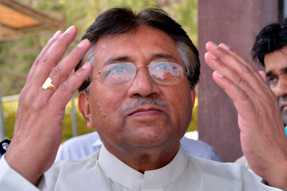 In this file photo taken on March 24, 2013 Pakistan’s former military ruler Pervez Musharraf prays after arriving at the Karachi International airport from Dubai, in Karachi/AFPPix