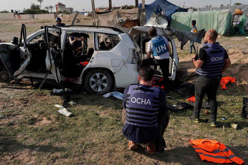 United Nations staff members inspect the carcass of a car used by US-based aid group World Central Kitchen, that was hit by an Israeli strike the previous day in Deir al-Balah in the central Gaza Strip - AFPpix