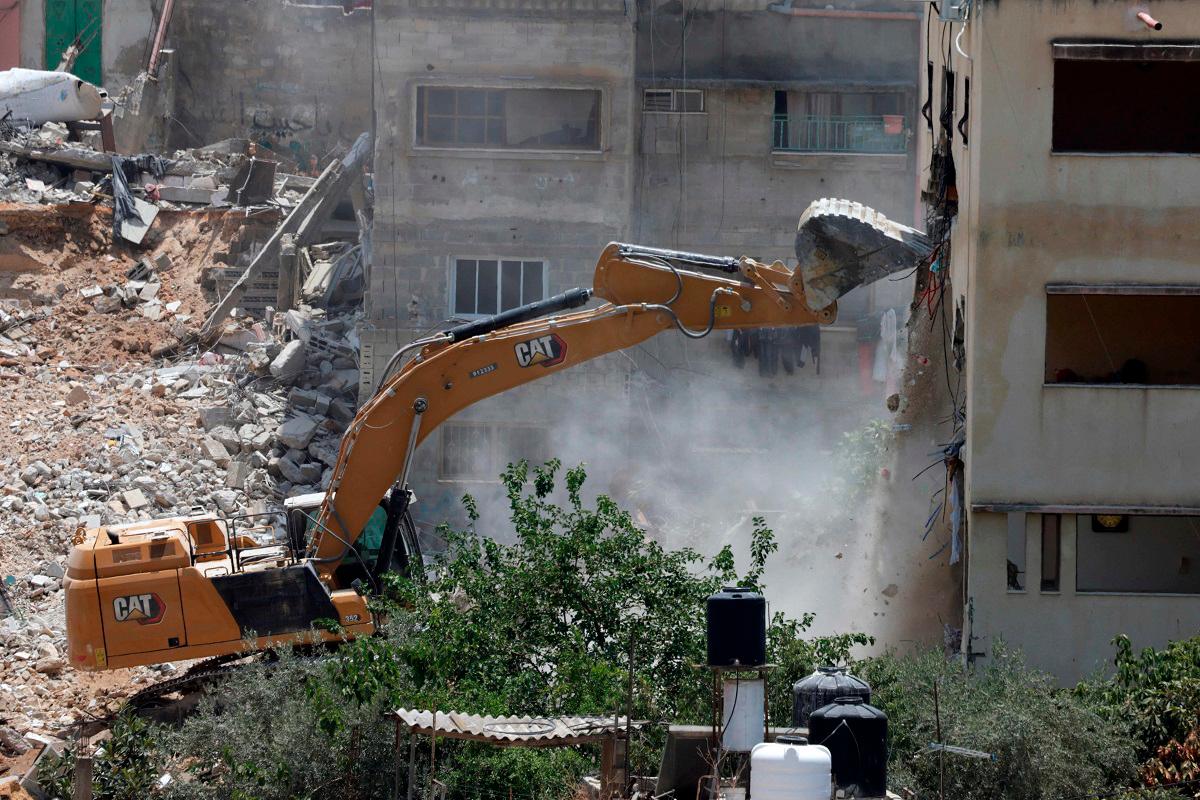 (FILES) An Israeli military bulldozer demolishes a home at the Nur Shams Palestinian refugee camp, east of Tulkarem, in the Israeli occupied West Bank on June 23, 2025, during an ongoing military operation in the north of the Palestinian West Bank. - AFPpix