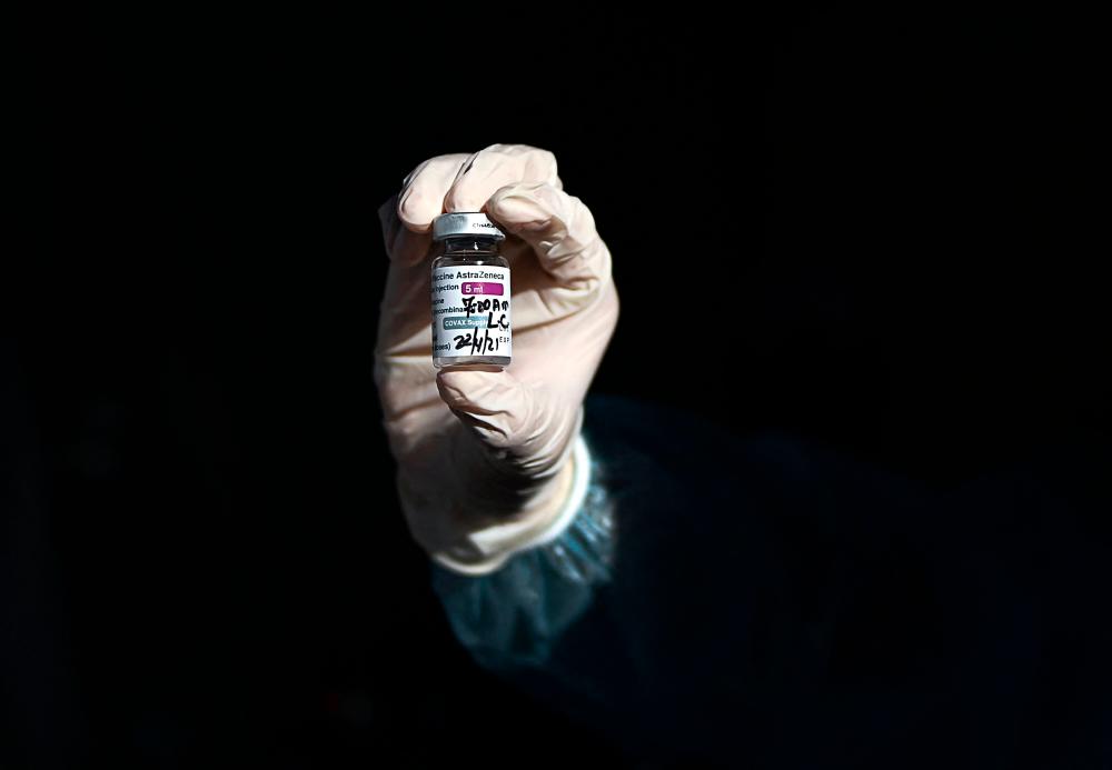 (FILES) In this file photo taken on April 22, 2021, a nurse shows a vial of the AstraZeneca vaccine against COVID-19 –AFP