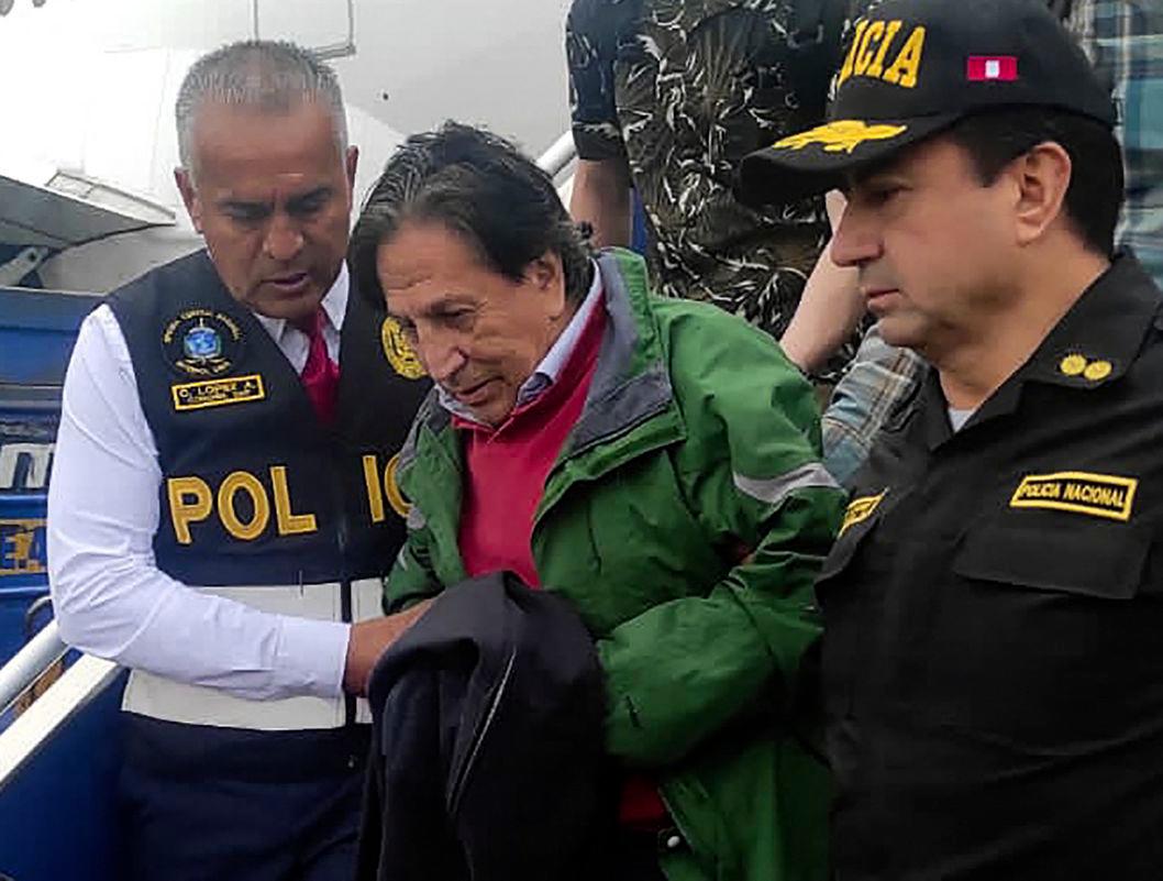 Handout picture distributed by the Peruvian National Police showing Peru’s former president Alejandro Toledo being escorted on arrival after being extradited from the United States, at the Jorge Chavez international airport in Callao, Lima, on April 23, 2023. - Handout /Peruvian National Police/AFPPIX