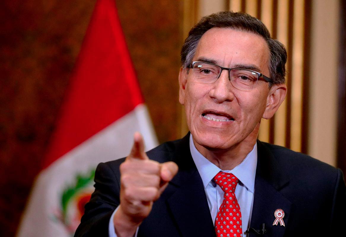 Handout picture released by the Peruvian presidency of President Martín Vizcarra speaking during a televised announcement to the Nation on July 5, 2020, in Lima, to announce he will call for a referendum in 2021 to decide on the elimination of parliamentary immunity. - (Photo by Andrés Valle/Peruvian Presidency/AFPPIX