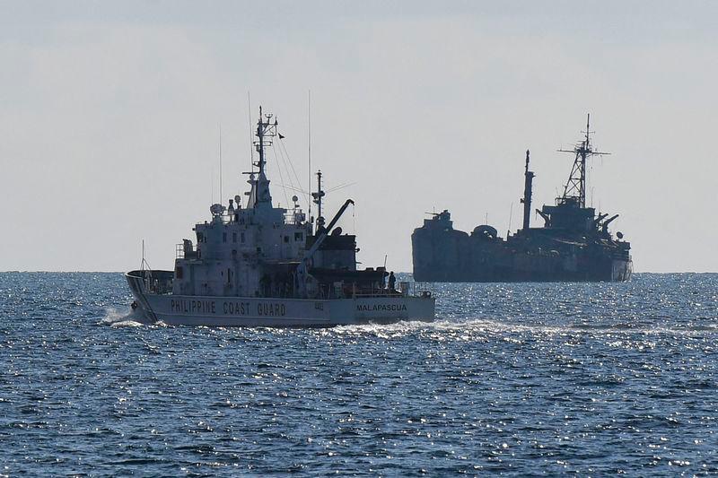 Philippine coast guard vessel BRP Malapascua (L) patrolling near the grounded navy ship BRP Sierra Madre where Philippine marines are stationed to assert Manila’s territorial claims at Second Thomas Shoal in the Spratly Islands in the disputed South China Sea - AFPpix