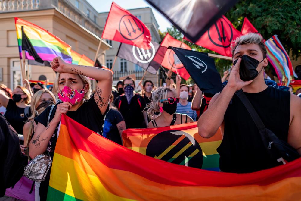 In this file photo taken on August 16, 2020 members of the LGBT community stage a protest during a counter demonstration against a demonstration of Polish nationalist, soccer hooligans and far right organisations members against the ‘LGBT’ rights movement in Warsaw. — AFP