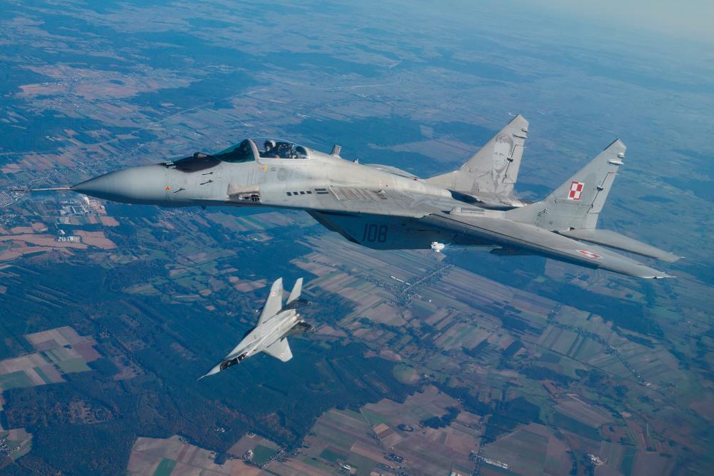 is file photo taken on October 12, 2022 shows two MiG 29 fighter jets taking part in the NATO Air Shielding exercise near the air base in Lask, central Poland. AFPPIX