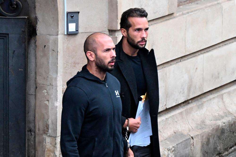 This file photo taken on January 10, 2023 shows British-US former professional kickboxer and controversial influencer Andrew Tate (L) and his brother Tristan Tate (R) exiting a court in Bucharest, Romania/AFPPix