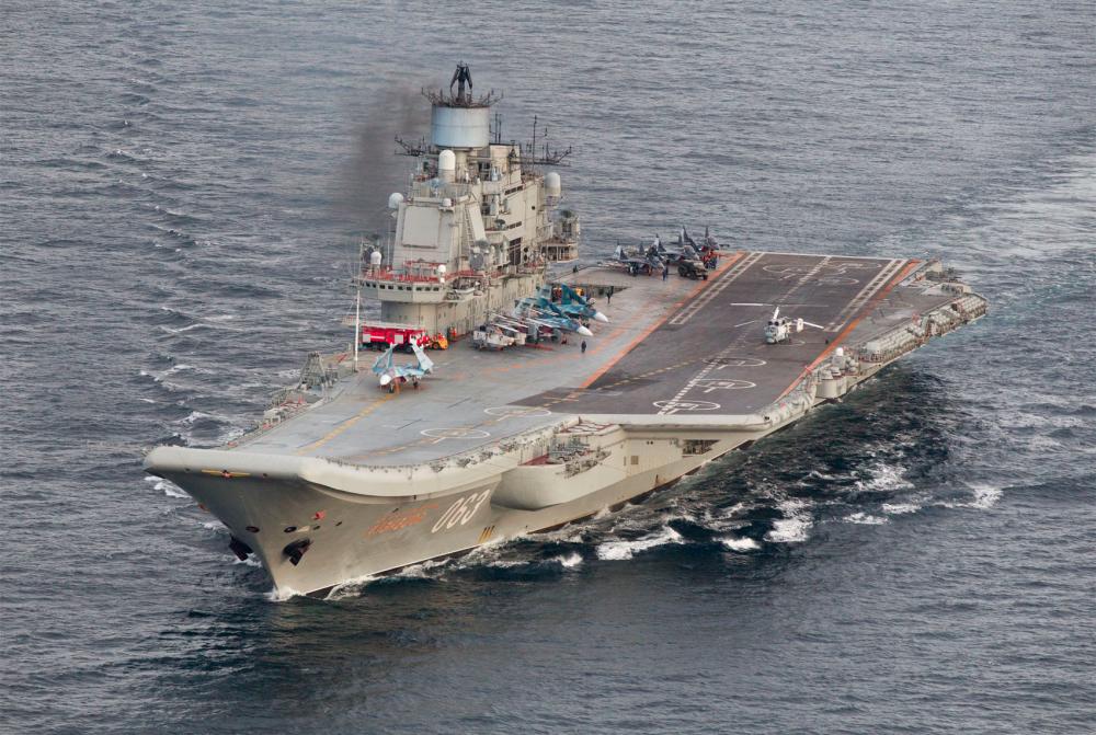A file handout photograph taken and released by the Norwegian Armed Forces Forsvaret on Oct 17, 2016 shows the Russian aircraft carrier Admiral Kuznetsov passing the Norwegian island of Andoya in the international waters on its way to the mediterranean sea. — AFP