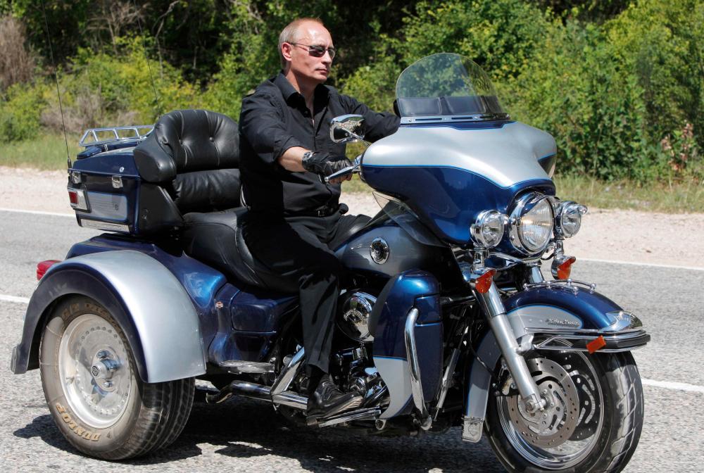 Russian Prime Minister Vladimir Putin rides Harley Davidson Lehman Trike as he leaves the meeting with motorbikers at their camp at Gasfort Lake near Sevastopol in Ukraine’s Crimea Peninsula. — AFP