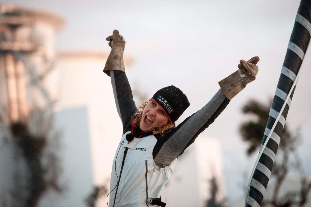 In this file photo taken on February 3, 2021 French skipper Clarisse Cremer celebrates aboard her Imoca 60 monohull “Banque Populaire X” after crossing the line of the Vendee Globe round-the-world solo sailing race, at Les Sables-d’Olonne, western France/AFPPix