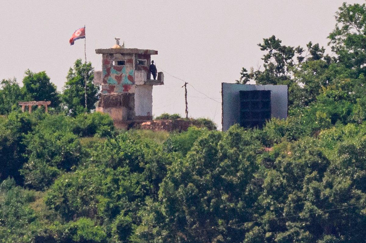 (FILES) This photo shows a North Korean soldier standing guard in a watch tower next to a giant loudspeaker (R), near the Demilitarized Zone (DMZ) dividing the two Koreas in Paju on June 12, 2025. The powerful sister of North Korea's leader on August 14, 2025, denied reports by the South Korean military that Pyongyang had removed propaganda loudspeakers along the border. - ANTHONY WALLACE / AFP