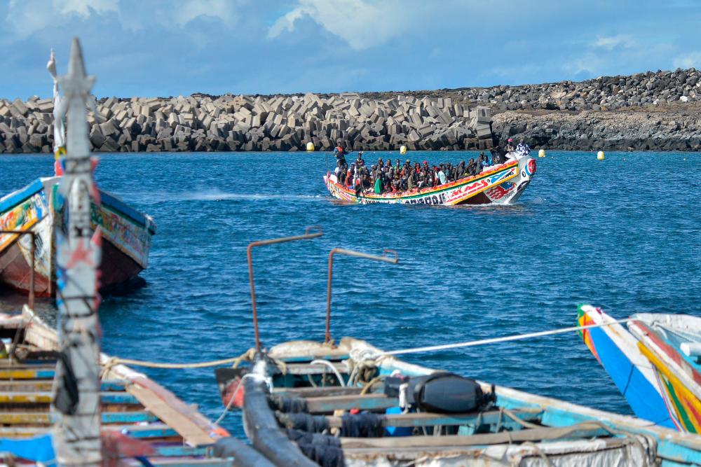 Migrants arrive on a boat at La Restinga dock, in the municipality of El Pinar on the Canary Island of El Hierro. - AFPPIX