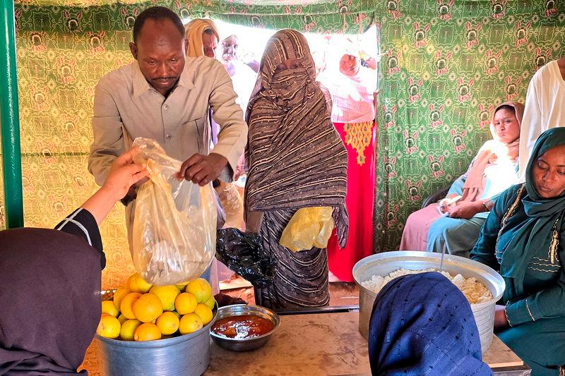 A man collects food at a location set up by a local humanitarian organisation to donate meals and medication to people displaced by the war in Sudan, in Meroe in the country’s Northern State, on January 9, 2025. For the first time in nearly two years of war, soup kitchens in famine-stricken Sudan are being forced to turn people away, with US President Donald Trump’s aid freeze gutting the life-saving schemes. AFPpix