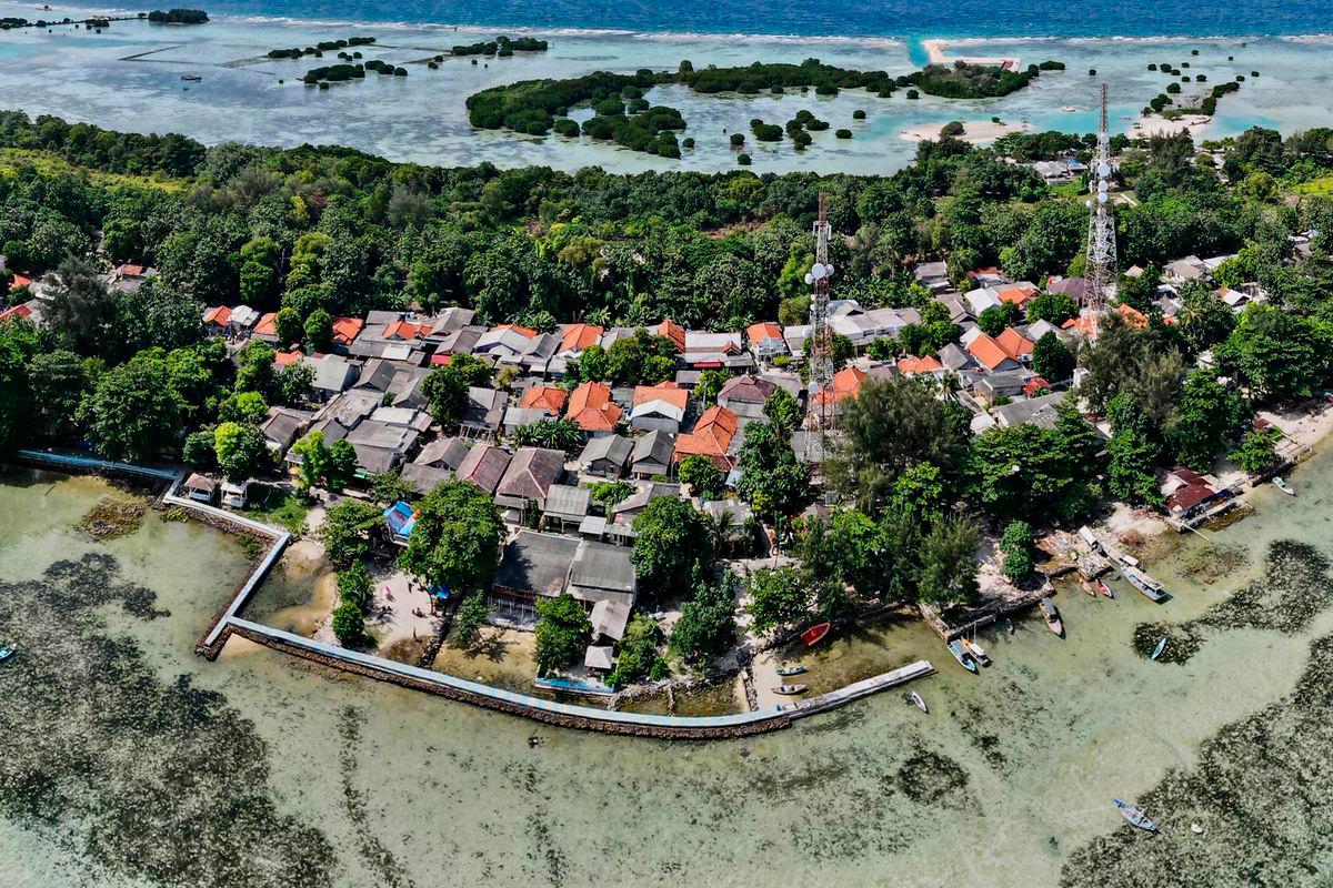 (FILES) In this aerial picture taken on February 22, 2023, a concrete embankment, used to stem rising sea levels, is seen around part of Pari island in the Thousand Islands cluster. (Photo by Bay ISMOYO / AFP)
