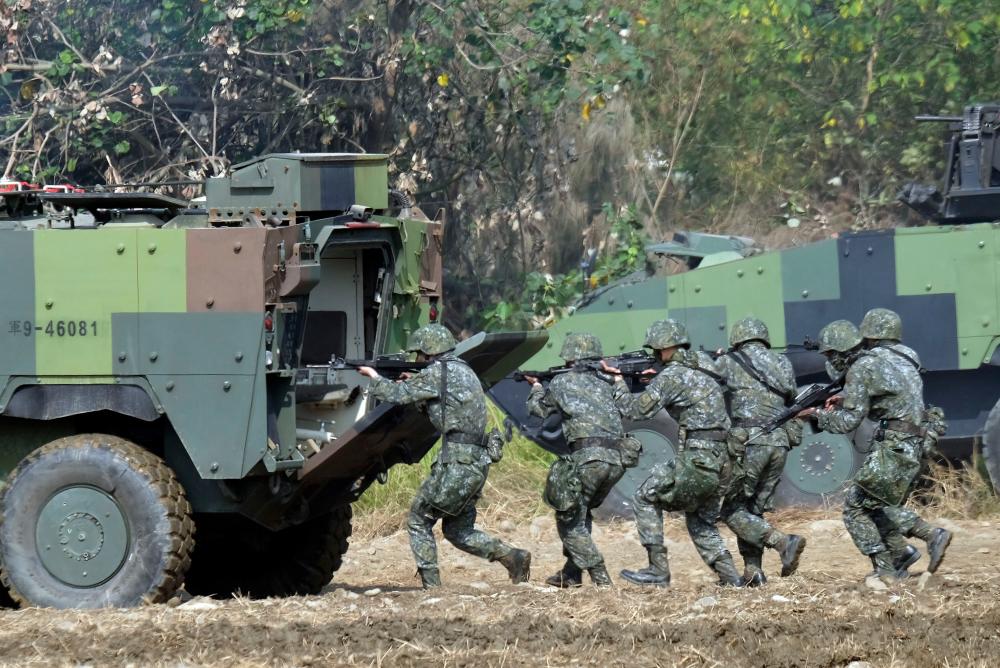 (FILES) In this file photo taken on January 17, 2017 Taiwan special forces personnel walk behind an armoured personnel carrier during an annual military drill in Taichung, central Taiwan. AFPpix