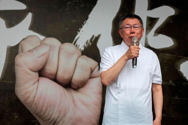 (FILES) Taiwan People's Party (TPP) chairman Ko Wen-je speaks on stage during a TPP protest against Taiwan's ruling Democratic Progressive Party (DPP) ahead of the inauguration ceremony of Taiwan's president-elect Lai Ching-te and vice-president-elect Hsiao Bi-khim in Taipei on May 19, 2024. Taiwan prosecutors on December 26 indicted an ex-mayor of Taipei and former presidential candidate on charges of corruption and misusing political donations and said they were seeking 28 years' jail for him.- Yasuyoshi CHIBA / AFP