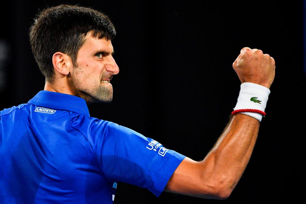 (FILES) This file photo taken on January 27, 2019 shows Serbia's Novak Djokovic reacting after a point against Spain's Rafael Nadal during the men's singles final on day 14 of the Australian Open tennis tournament in Melbourne. World number one Novak Djokovic was among the entries for the Australian Open on December 8, 2021, but women's great Serena Williams was missing. AFPpix
