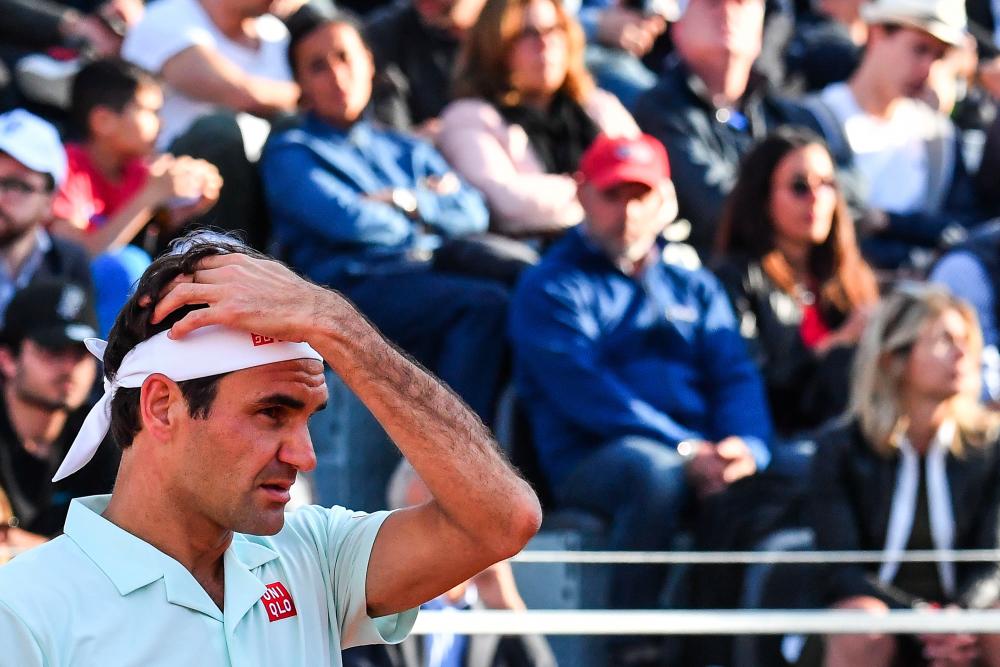In this file photo taken on May 16, 2019 Switzerland's Roger Federer reacts as he lose a point against Croatia's Borna Coric during their ATP Masters tournament tennis match at the Foro Italico in Rome. - AFP