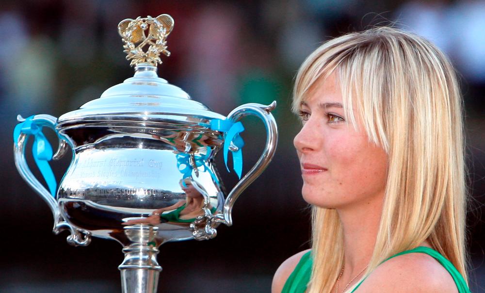 In this file photo taken on January 26, 2008, Maria Sharapova of Russia poses while holding the women's singles trophy on a boat along the Yarra river in Melbourne following her victory at the Australian Open tennis tournament. - AFP