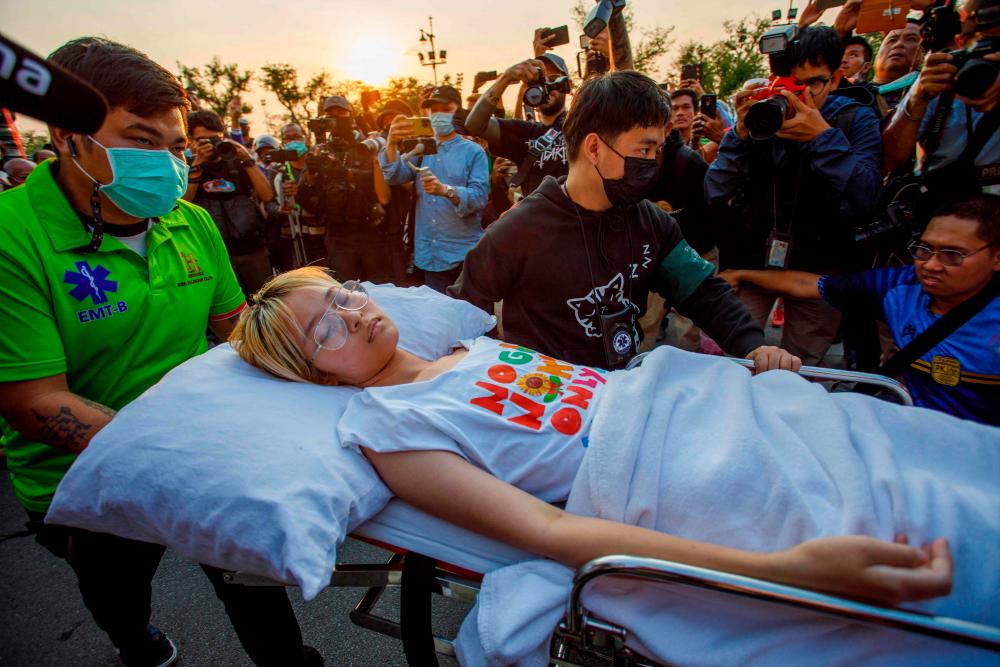 This file photo taken on February 24, 2023 shows Thai political activist Orawan “Bam” Phuphong being transported on a stretcher to continue a hunger strike outside Thailand’s Supreme Court after being released from Thammasat Hospital in Bangkok. AFPPIX