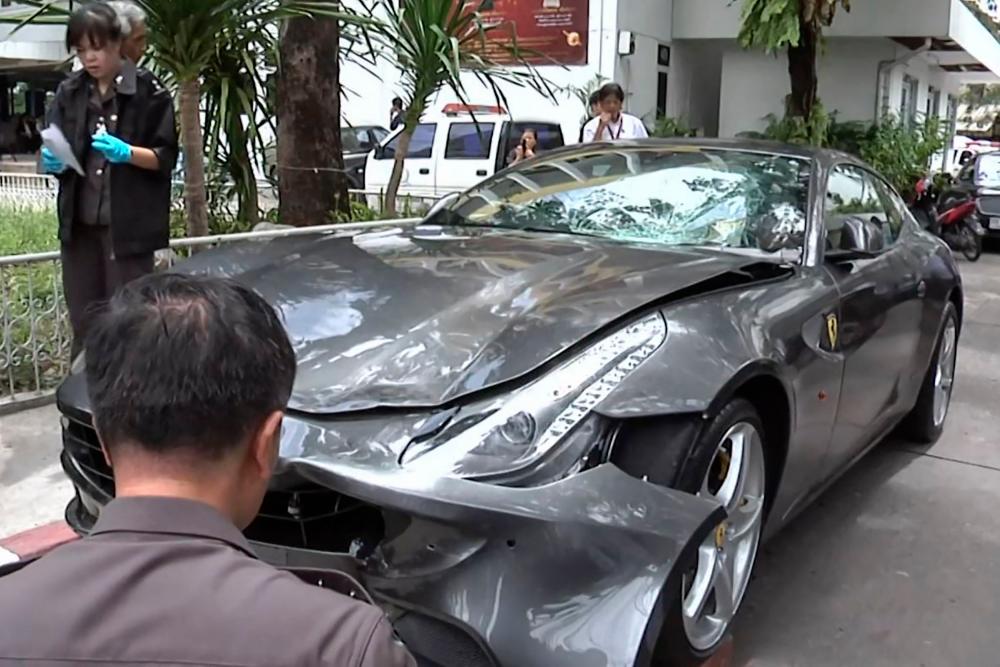 This file frame grab from video footage taken on September 3, 2012 and received from Thai PBS via AFPTV on September 1, 2020 shows police inspecting the Ferrari car belonging to Red Bull heir Vorayuth “Boss” Yoovidhya in Bangkok, after a hit-and-run case which resulted in the death of a police officer/AFPPix