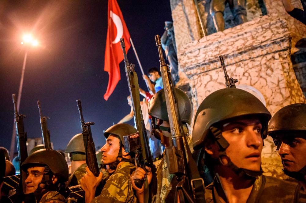 In this file photo taken on July 16, 2016 Turkish solders stay at Taksim square as people protest against the military coup in Istanbul on July 16, 2016. – AFP