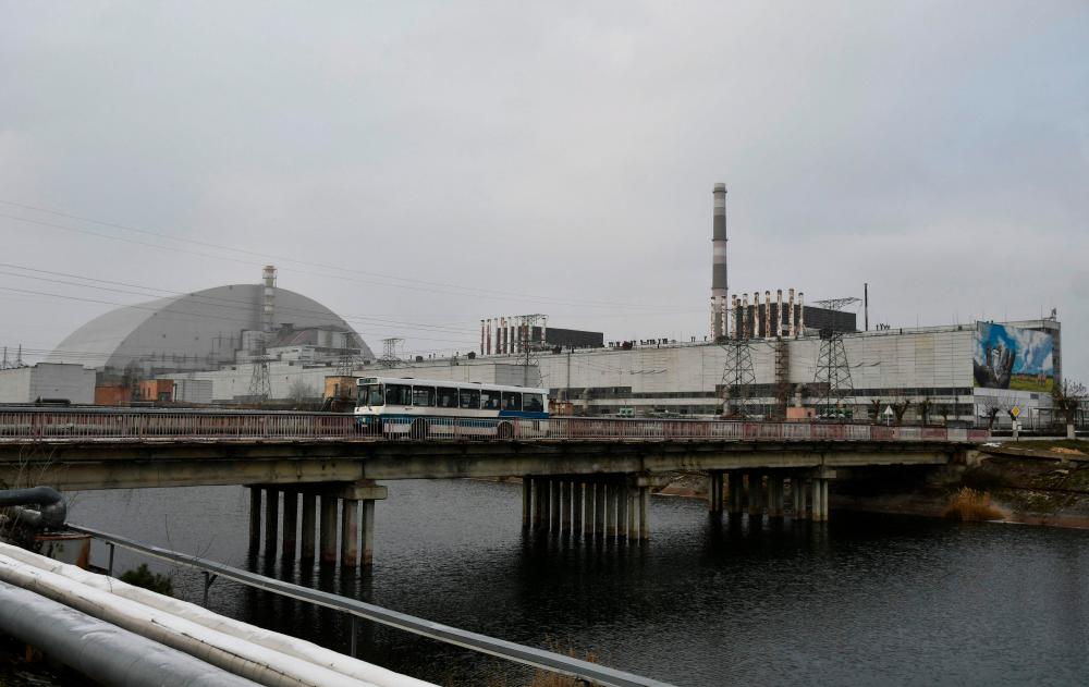 (FILES) This file photograph taken on December 8, 2020 shows a general view of Chernobyl nuclear power plant and giant protective dome built over the sarcophagus of the destroyed fourth reactor. AFPPIX